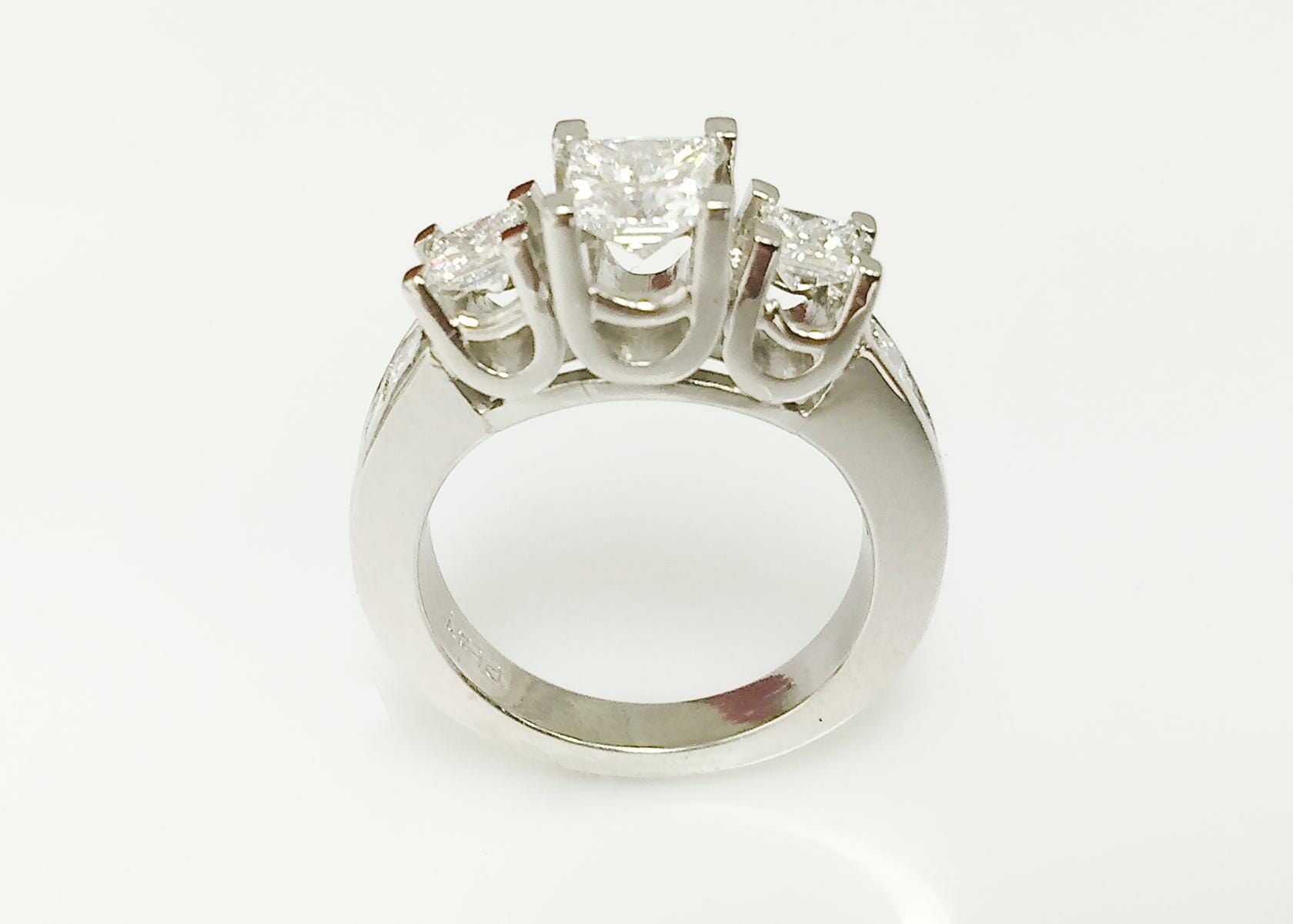 Mary platinum three stone ring with side diamonds front view